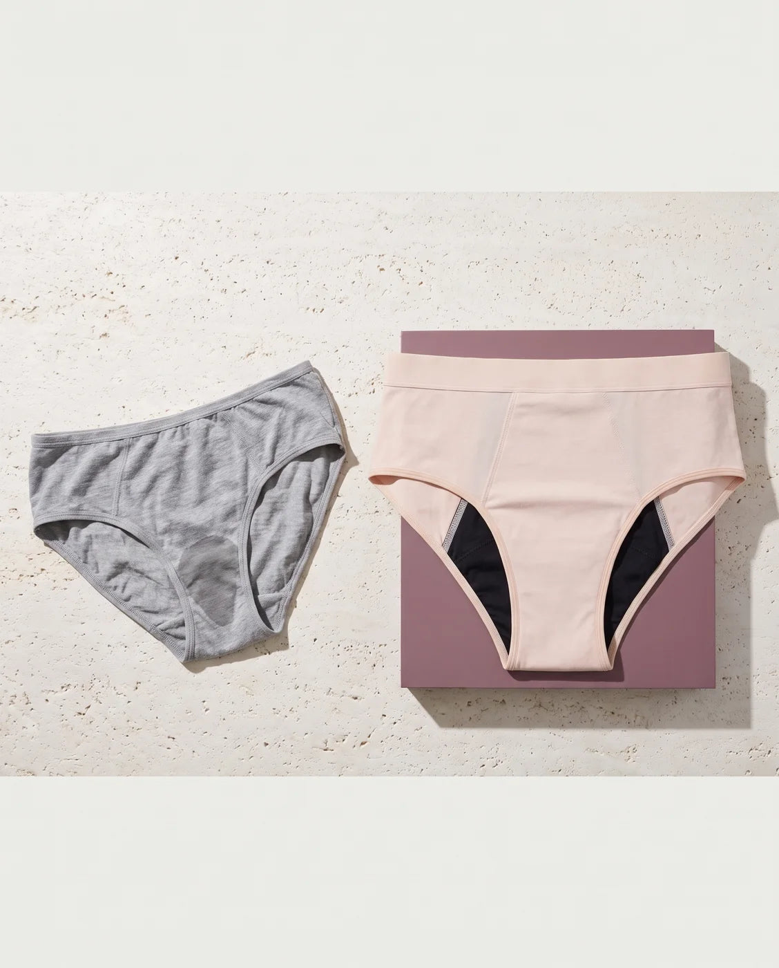 Gray underwear beside a sand-colored pair of absorbent underwear, continuing the menopause ad comparison
